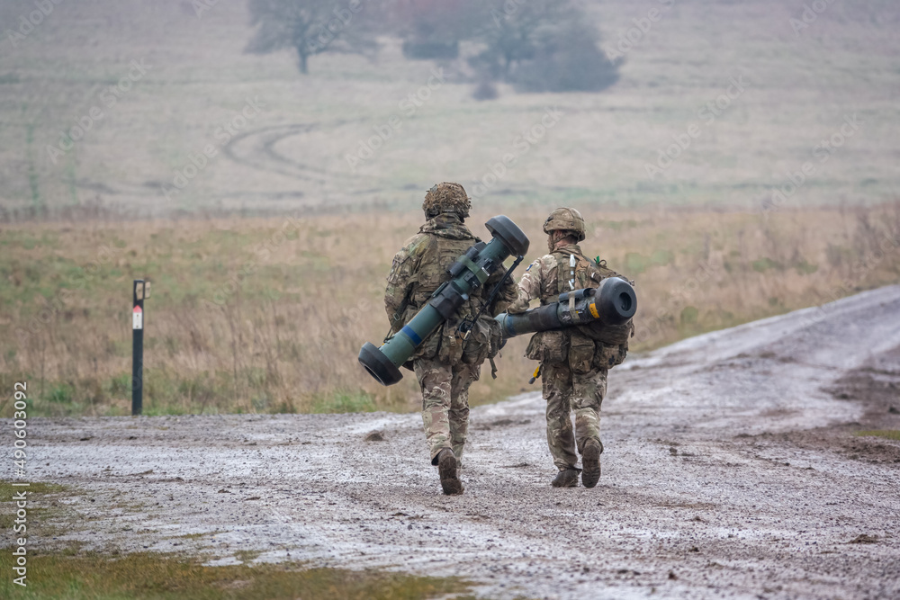 army soldier completing an 8 mile combat fitness test tabbing exercise with fully loaded 25Kg bergen and anti-tank guided missile army soldier completing an 8 mile combat fitness test tabbing exercise with fully loaded 25Kg bergen and anti-tank guided missile