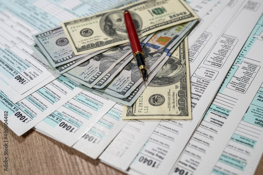 1040 us tax form. financial docs with dollar on desk 1040 us tax form. financial docs with dollar on desk