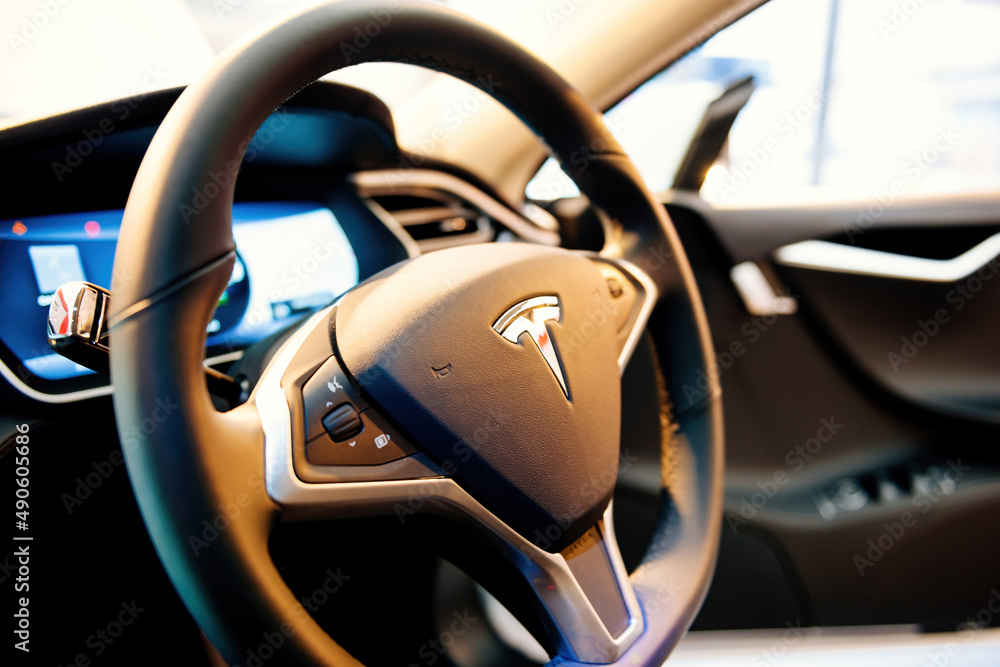 Paris, France - Nov 29, 2014: Steering wheel of a new Tesla Model S 3  electric car with multiple buttons on the control area Stock Photo