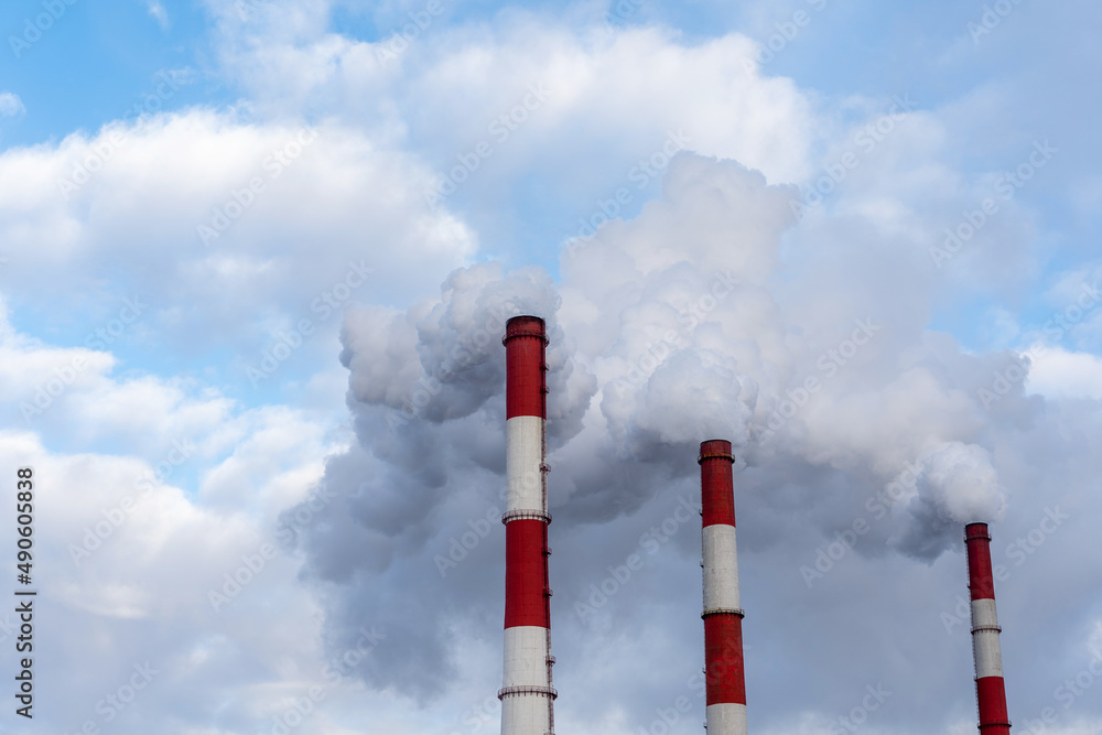 Thick smoke coming from three factory chimneys. Thick smoke coming from three factory chimneys.