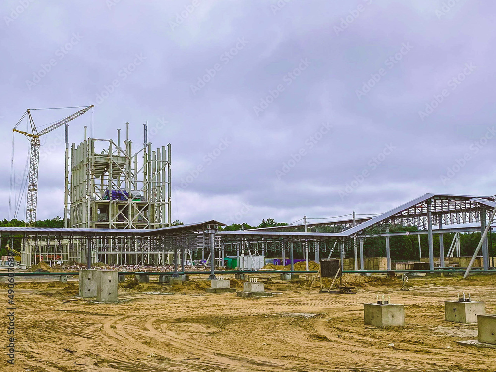 construction of buildings and structures in the industrial complex. metal structures, reinforcement from the earth. high construction cranes at a construction site construction of buildings and structures in the industrial complex. metal structures, reinforcement from the earth. high construction cranes at a construction site