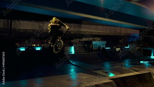 Wallpaper Mural Extreme bmx biker jumping on ramp with bicycle at night outdoors.  Torontodigital.ca