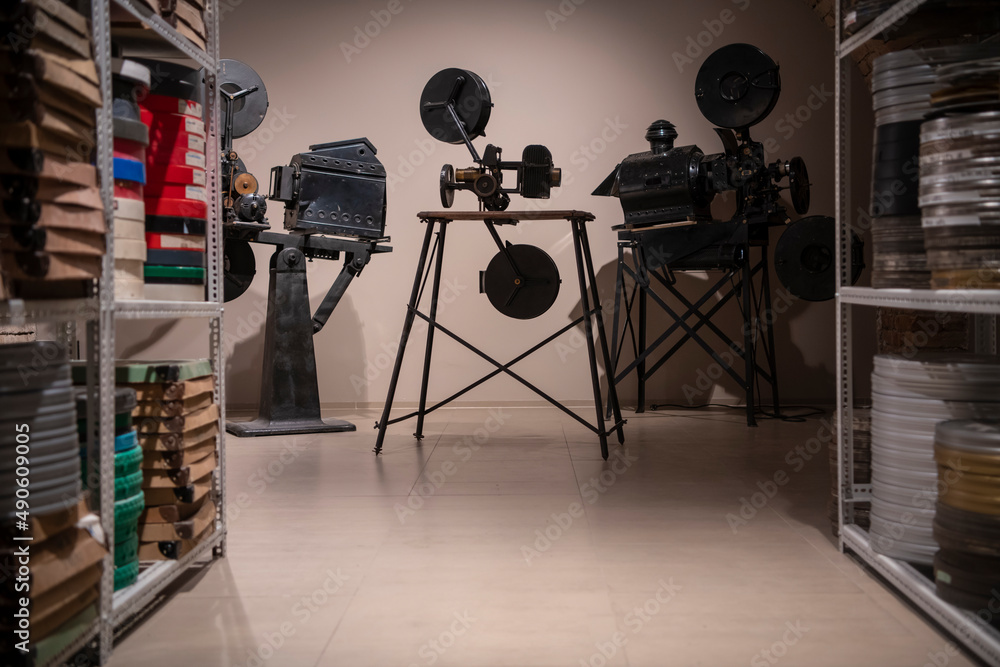 Ταπετσαρία Vintage photo of cinema library with old video movie projectors and film reels on shelves