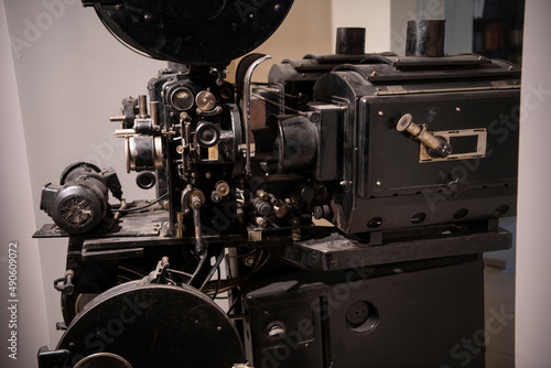 Closeup photo of old vintage movie projector in cinema library.