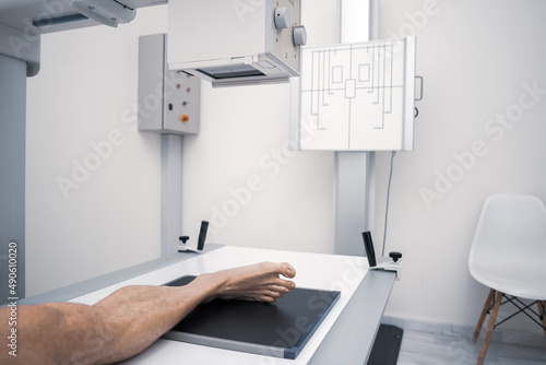 patient in an x-ray room. X-ray of the human foot. Classic ceiling mounted X-ray system. Medical equipment