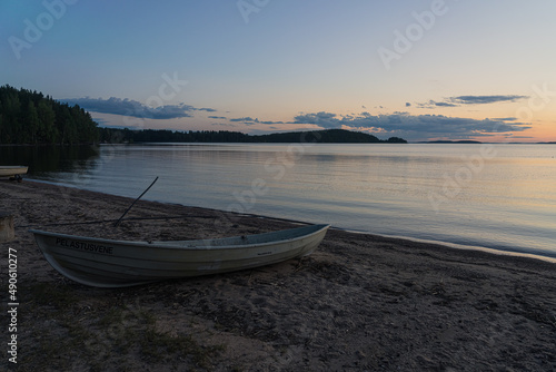 Fototapeta Naklejka Na Ścianę i Meble -  Seascape and a boat on the shore. Peaceful, calm, evening sky and sea. Natural background. Summer evening.