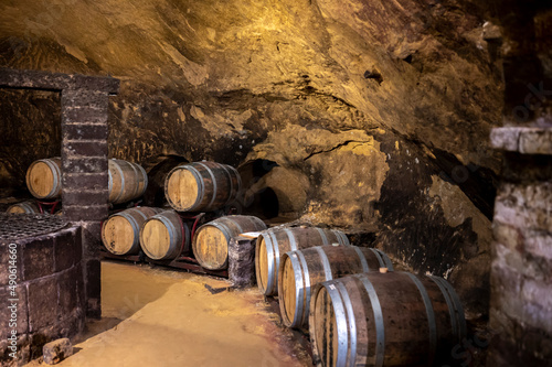 Medieval underground wine cellars with old red wine barrels for aging of vino nobile di Montepulciano in old town Montepulciano in Tuscany, Italy