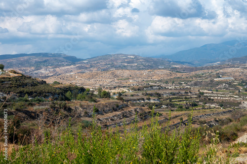 Aerial view on Troodos mountains, fertile valley with vineyards and olive groves and white roads, Cyprus