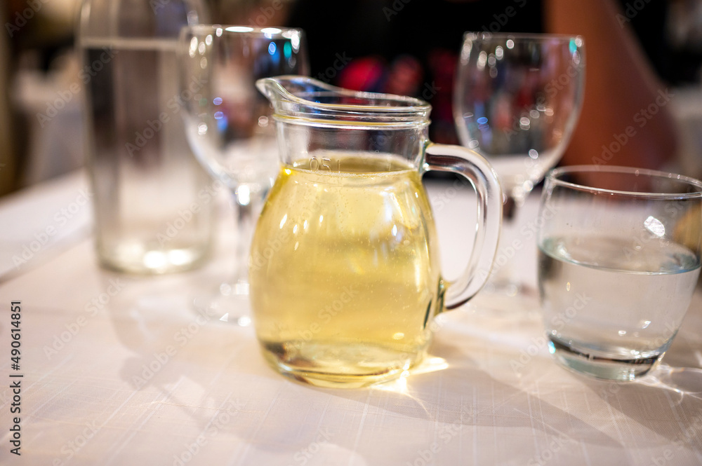 Italian white house wine served in pitcher with two glasses for dinner