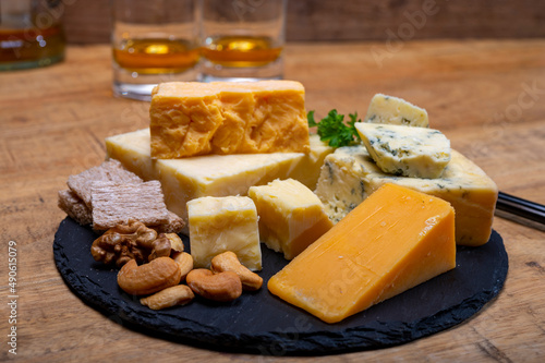 British drinks and food, glasses of Scotch whisky and cheeses collection, blue Stilton, Scottish coloured and English matured cheddar cheeses