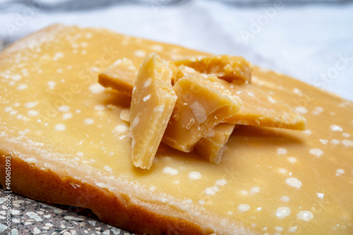 72 months very old Italian parmigiano-reggiano parmesan cheese from Parma has amber color, dry, extremely grainy and crumbly with very intense taste.