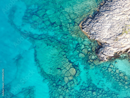 Crystal clear blue water of Mediterranean sea on Fig tree beach in Protaras, Cyprus, top view