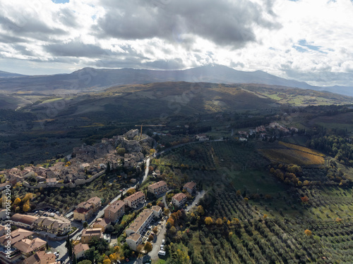 Aerial view on hills near Castiglione, Tuscany, Italy. Tuscan landscape with cypress trees, vineyards, forests and ploughed fields in autumn.