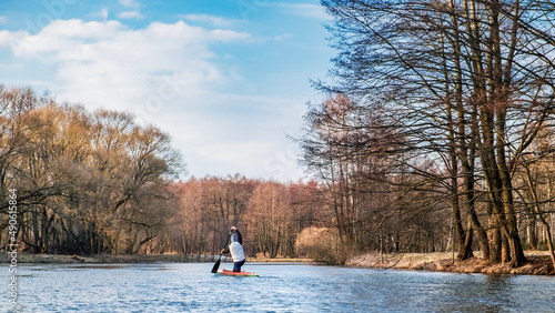 MINSK, BELARUS - March 03, 2022: A lone paddler sails down the river in a canoe in early spring