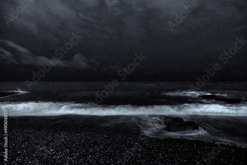 Night photo. Old ruined pier and sea with a full moon. Night Sea Surf.