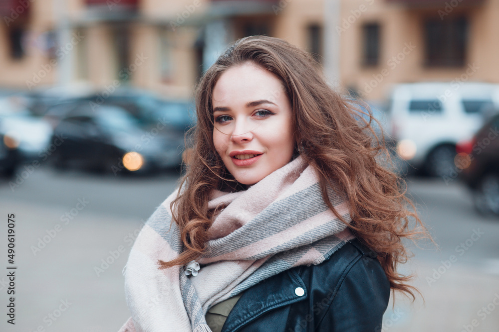 Young woman walking on street in cold spring day in city Young woman walking on street in cold spring day in city