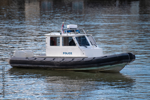 Police coast guard motor boat on water surface. Police patrol boat on the River in action. Emergency response