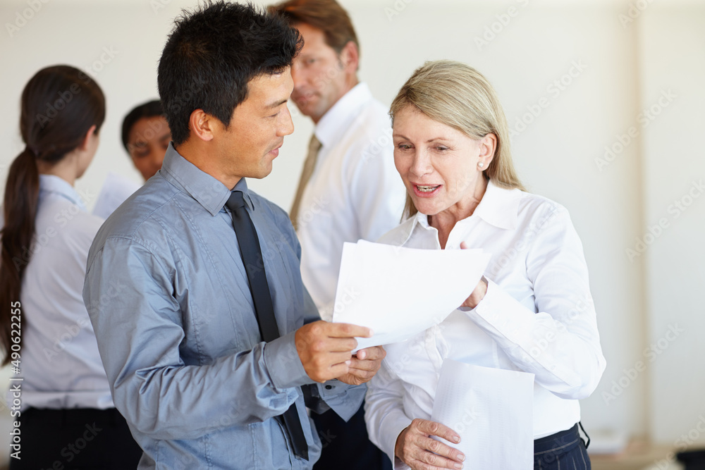 Help from an experienced eye never hurts. Two business professionals discussing a document. Help from an experienced eye never hurts. Two business professionals discussing a document.
