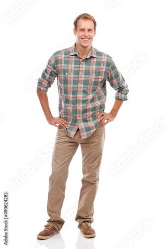 Enjoying the casual life. Portrait of a handsome young man standing with his hands on his hips against a white background.