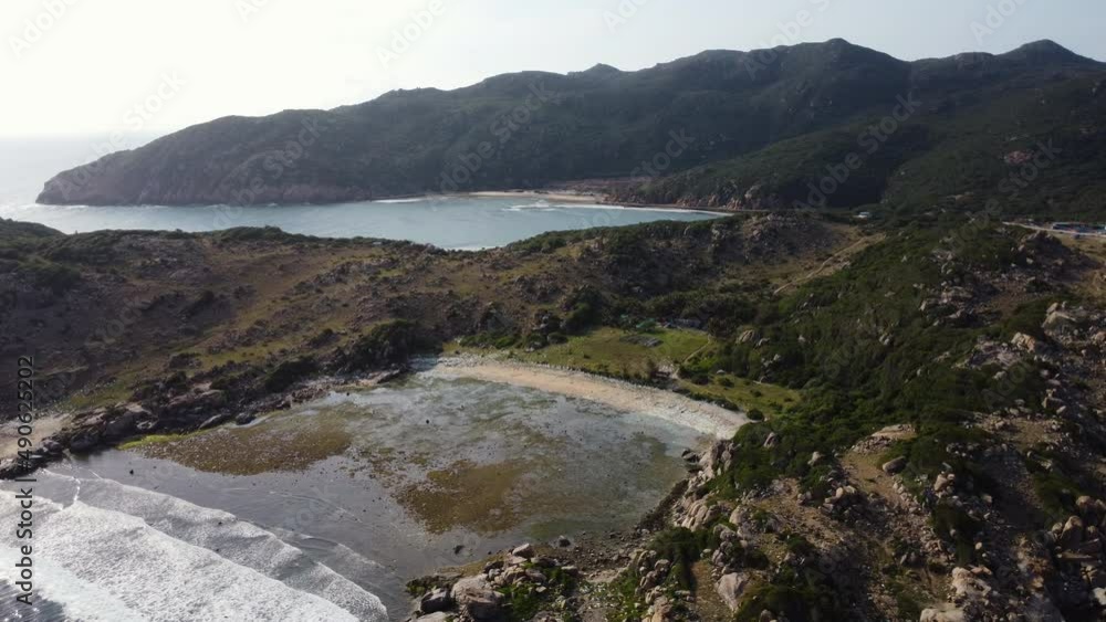 Aerial view of vietnamese bay with mountains and coastline during sunny day - Beautiful drone panorama shot of reflecting water and bright sky Aerial view of vietnamese bay with mountains and coastline during sunny day - Beautiful drone panorama shot of reflecting water and bright sky