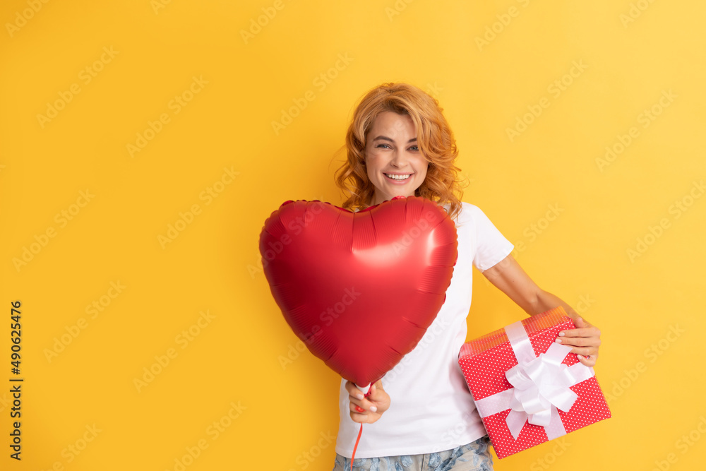 glad redhead lady with romantic gift and party balloon. happy valentines day glad redhead lady with romantic gift and party balloon. happy valentines day