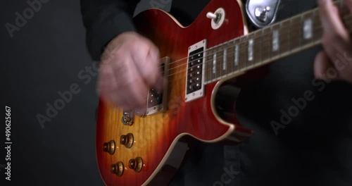 A Rock Guitarist Making Music On Stage. Playing Electric Guitar. Close Up Shot.