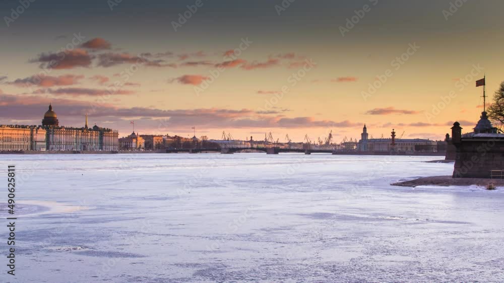 Russia, Saint-Petersburg, Time lapse of the water area of the Neva River at sunset, the Winter Palace, Palace Bridge, the dome of St. Isaac Cathedral, pink clouds, frozen river Russia, Saint-Petersburg, Time lapse of the water area of the Neva River at sunset, the Winter Palace, Palace Bridge, the dome of St. Isaac Cathedral, pink clouds, frozen river