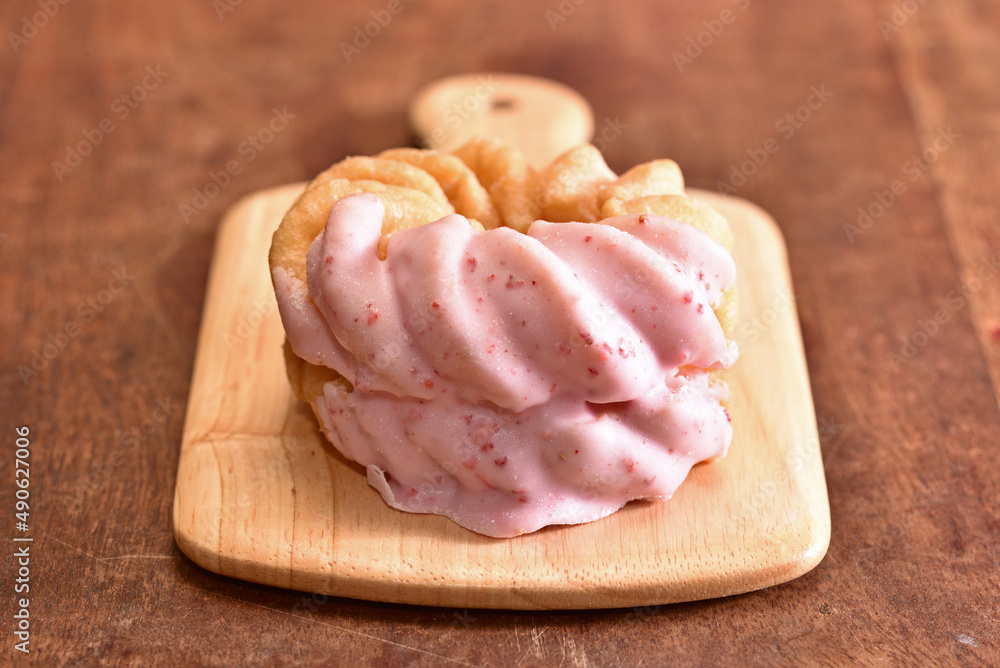 Strawberry french donut on wooden tray