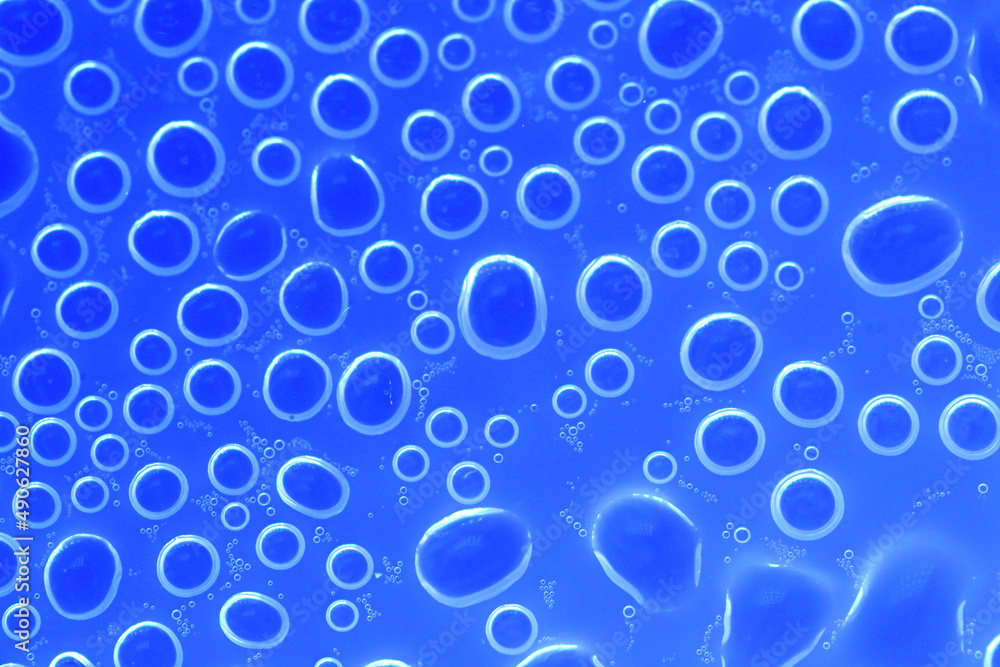 Water bubbles surface.wallpaper phone. background with round drops in blue tones. Water bubbles and drops texture.blue circles pattern