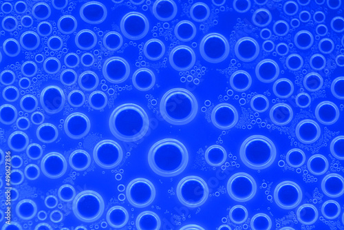 Water bubbles surface.blue circles pattern. wallpaper phone. background with round drops in blue tones. Water bubbles and drops texture.