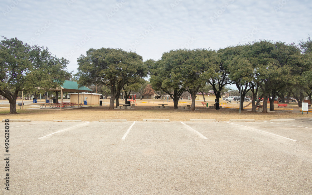 Empty parking lot area in Allcorn Park, a public park in Brownwood Texas. 