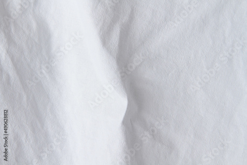 Texture of white fabric. White background close up. Factory fabric in white.