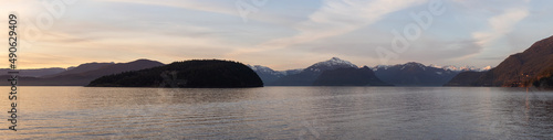 Panoramic View of Canadian Nature Mountain Landscape on the Pacific Ocean West Coast. Colorful Winter Sunset. Taken in Howe Sound near Horseshoe Bay, West Vancouver, BC, Canada. Background Panorama