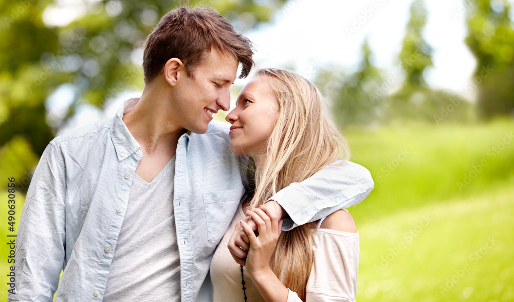 Theyve only got eyes for one another. Young couple standing together in the park. Theyve only got eyes for one another. Young couple standing together in the park.