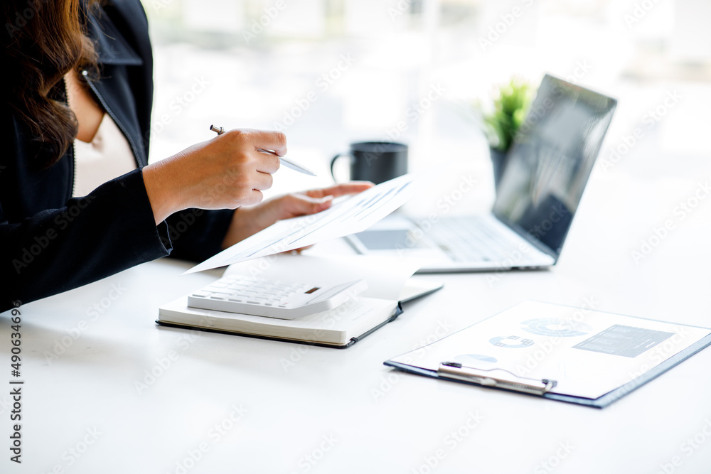 Financial Businesswoman working at office with documents on his desk, doing planning analyzing the financial report, business plan investment, finance analysis concept Financial Businesswoman working at office with documents on his desk, doing planning analyzing the financial report, business plan investment, finance analysis concept