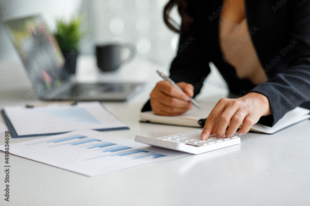Financial Businesswoman working at office with documents on his desk, doing planning analyzing the financial report, business plan investment, finance analysis concept Financial Businesswoman working at office with documents on his desk, doing planning analyzing the financial report, business plan investment, finance analysis concept
