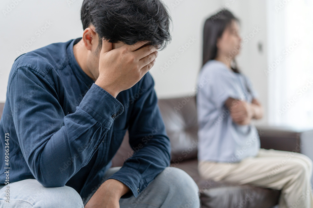 Asian man are disappointed and saddened after an argument with wife. Asian couples are having family problems resulting in divorce. Lover broken and Love problem Asian man are disappointed and saddened after an argument with wife. Asian couples are having family problems resulting in divorce. Lover broken and Love problem