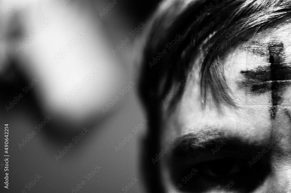 Caucasian male with ash cross on forehead. Traditionally applied during Ash Wednesday as part of Christian faith at the start of Lent. Caucasian male with ash cross on forehead. Traditionally applied during Ash Wednesday as part of Christian faith at the start of Lent.