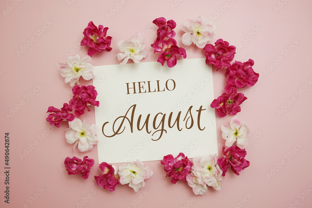 Hello August card typography text with flower bouquet on pink background