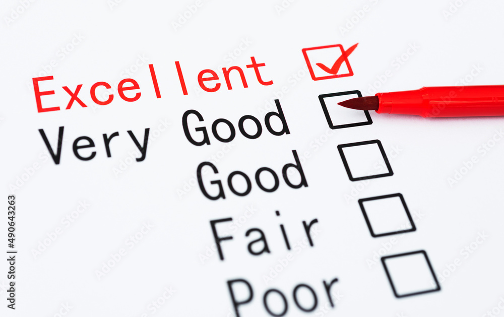 Pen checking the word Excellent in a survey Pen checking the word Excellent in a survey