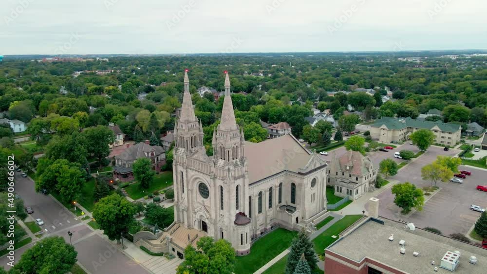 Aerial view of religious church with immaculately landscaped property. Residential homes in the neighborhood around the property with tree lined streets. Aerial view of religious church with immaculately landscaped property. Residential homes in the neighborhood around the property with tree lined streets.