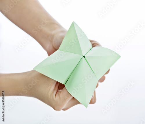 Hand in paper fortune teller isolated on white background