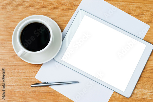 Digital tablet and a cup of coffee on the desk