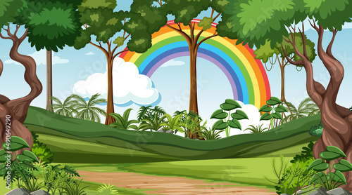 Nature forest scene with rainbow in the sky