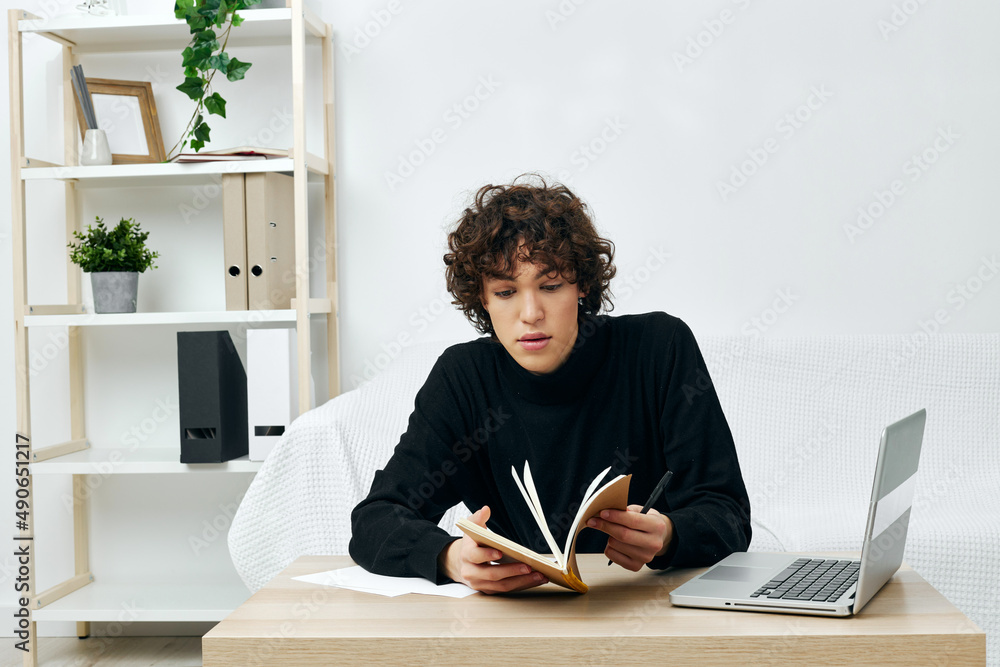 curly guy laptop sitting on white sofa online training communication curly guy laptop sitting on white sofa online training communication