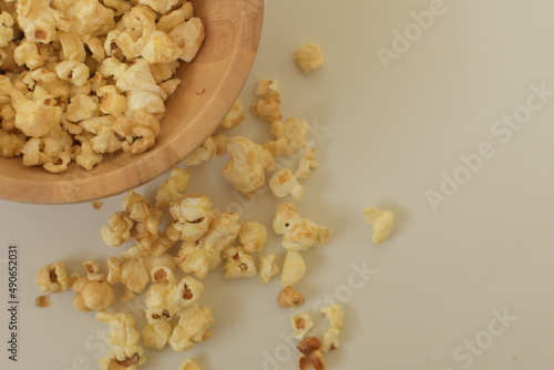 popcorn in a wooden bowl snack with white background close up