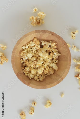 popcorn in a wooden bowl snack with white background