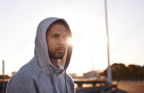 Focused on his fitness goals. A focused young sportsman wearing a hoodie and looking away.