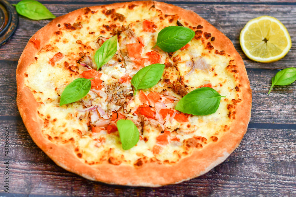 Home made Tuna fish italian style pizza. Parmesan cheese, mozzarella , mushrooms,olives cherry tomatoes and ,fresh basil Home made Tuna fish italian style pizza. Parmesan cheese, mozzarella , mushrooms,olives cherry tomatoes and ,fresh basil