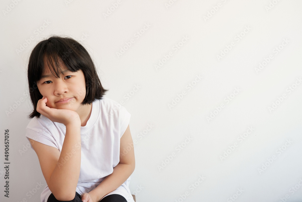 A photograph of a young woman contemplating on a plastered background. before morning exercise with the face showing bad symptoms